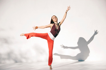 Dancing yoga woman. Photographed on a white background. 