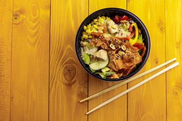 Bowl with tasty healthy food on wooden table