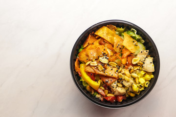 Bowl with tasty healthy food on wooden table