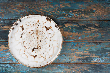 Empty plate with fork and knife on colored wooden background, top view, copy space, mock-up