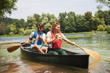couple of explorers conoining on wild river