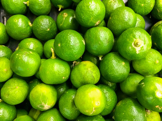 Green lemons background, Fruit in the market.