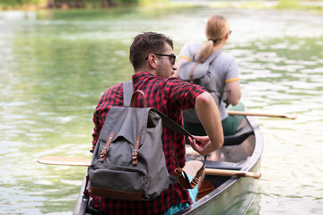 couple of explorers conoining on wild river