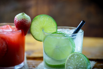Traditional brazilian caipirinha alcoholic cocktail with sugar, mint and brown sugar. Fruit with cachaça, Brazilian tradition.