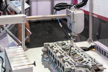 close up suction head and valve shaft during catch remove or assembly in cylinder block engine of vehicle or automobile by automation pneumatic system control