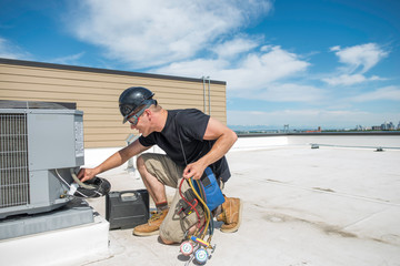 HVAC tech by Condenser