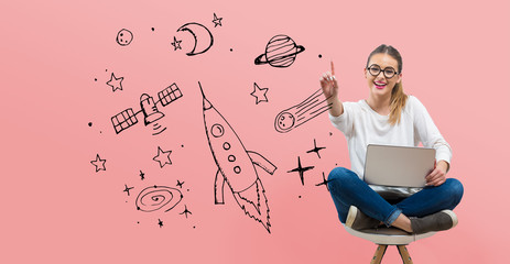 Dream of space and rocket with young woman using her laptop