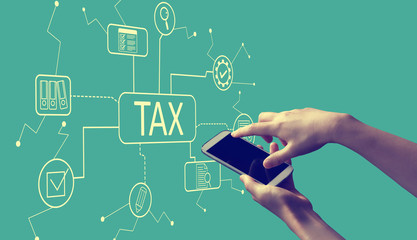 Tax theme with person holding a white smartphone