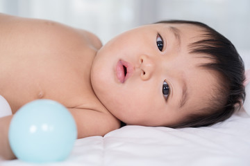 close up baby lying on bed