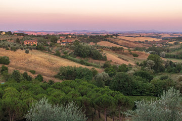 Naklejka premium Beautiful landscape of Tuscany, near Siena, at sunset hour with dusk