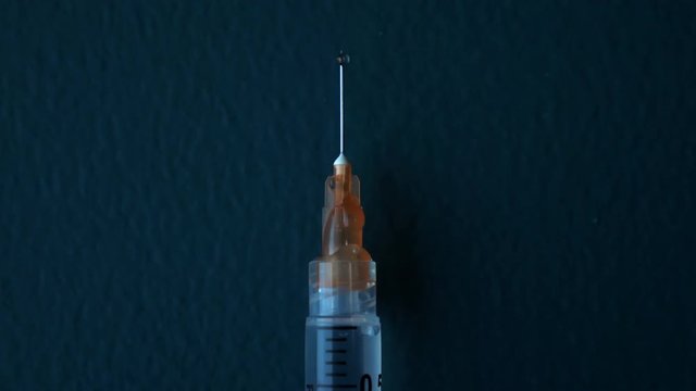 Syringe needle drops CLOSE UP 4K