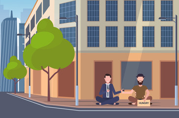 business man drinking coffee talking with beggar sitting on city street hungry sign board begging for help homeless jobless concept building exterior cityscape background full length horizontal