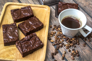 Nutella Brownie with americano coffee and coffee bean on the wood table