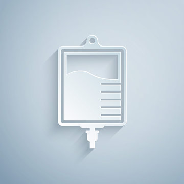 Paper cut IV bag icon isolated on grey background. Blood bag icon. Donate blood concept. The concept of treatment and therapy, chemotherapy. Paper art style. Vector Illustration