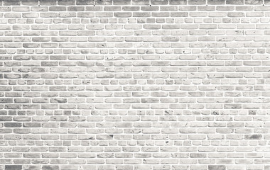 Fototapeta na wymiar White brick wall. Simple grungy white brick wall with light gray shades pattern surface texture background in wide format.