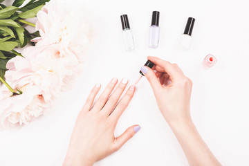 Nail polish bottles in woman hands.