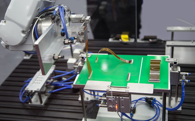 Automated robot connecting Flexible flat cable FFC on print circuit board (PCB). Electronics industry
