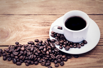 A cup of coffee and scattered coffee beans. Layout. Flat lay. Coffee bean.