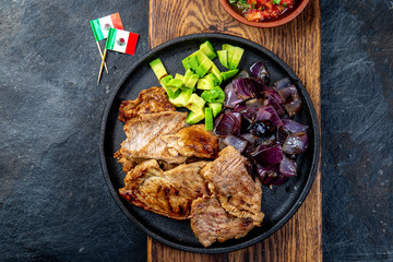 Yucatan Mexican Food Pork POC CHUC poc chuck. Pork marinaded in orange juice served with avocado, purple onion and rustic tomato sauce.
