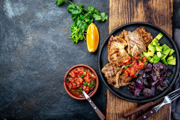 Yucatan Mexican Food Pork POC CHUC poc chuck. Pork marinaded in orange juice served with avocado, purple onion and rustic tomato sauce.