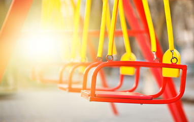 Children's swing at the playground outdoor close-up.