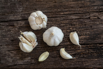 Top view of herbal vegetable ingredients, fresh garlic, on old wooden table, cooking preparation concept