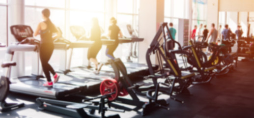 Fototapeta Blurred photo of a gym with people on treadmills obraz