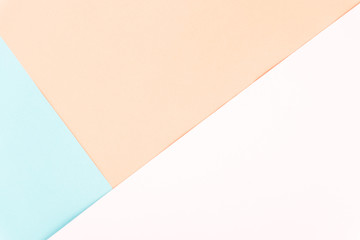 Flat layout of minimal colourful layer of pastel pink, blue and orange paper background.