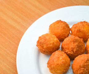 Cheese balls, Breaded mozzarella cheese balls with tomato in white dish on wood blackground