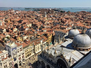 Fototapeta na wymiar A view from the top of St Marks Campanile of St Marks Square and Basilica, Doges Palace, the amazing city of Venice, and the Grand Canal in the background on a beautiful sunny day,