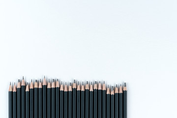 set professional black slate pencil for drawing lies on white cardboard background. Copy space. Mock ap.
