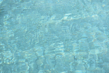 Water surface in a swimming pool. Blurred abstract background