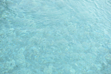 Water surface in a swimming pool. Blurred abstract background