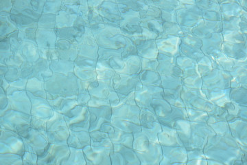 Water surface in a swimming pool. Blurred abstract background
