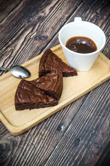 Nutella Brownie with americano coffee and coffee bean on the wood table