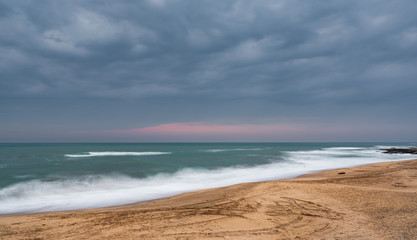 Blurred wave motion and empty beach