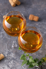 White wine in a glass. The concept of winemaking. Place under your text. Still life on a textural background.