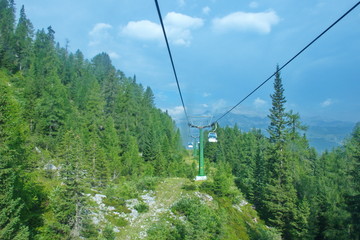 Cable car going through the woods from Madonna di Campiglio to Groste pass in Dolomites, Italy