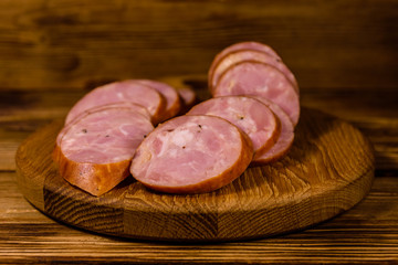 Cutting board with sliced sausage on a wooden table