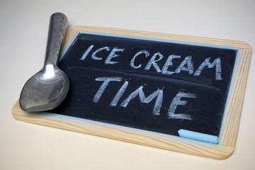 Ice cream time message on chalkboard with scoop