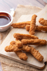 Hot and spicy Korean barbeque fried chicken on wood cutting board