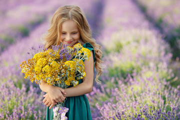 Little girl in a field with flowers. 