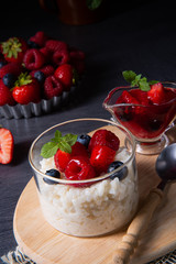 delicious milk rice with different berries and red fruit jelly