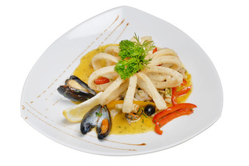 Salad from vegetables and seafood with olives and lemon on a square plate on a white isolated background