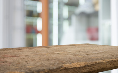 Empty of wood table top on blur of curtain with window view green from tree garden background.For montage product display or design key visual layout