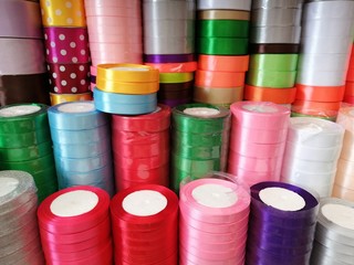 beautiful bright background folded colorful ribbons for decorating gifts