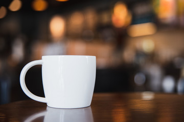 cup of coffee on wooden table in coffee shop with copy space