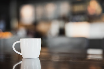 cup of coffee on wooden table in coffee shop with copy space