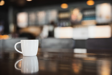 cup of coffee on wooden table in coffee shop with copy space