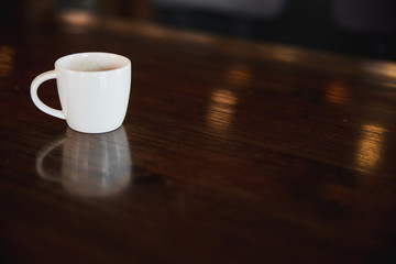 cup of coffee on wooden table in coffee shop with copy space
